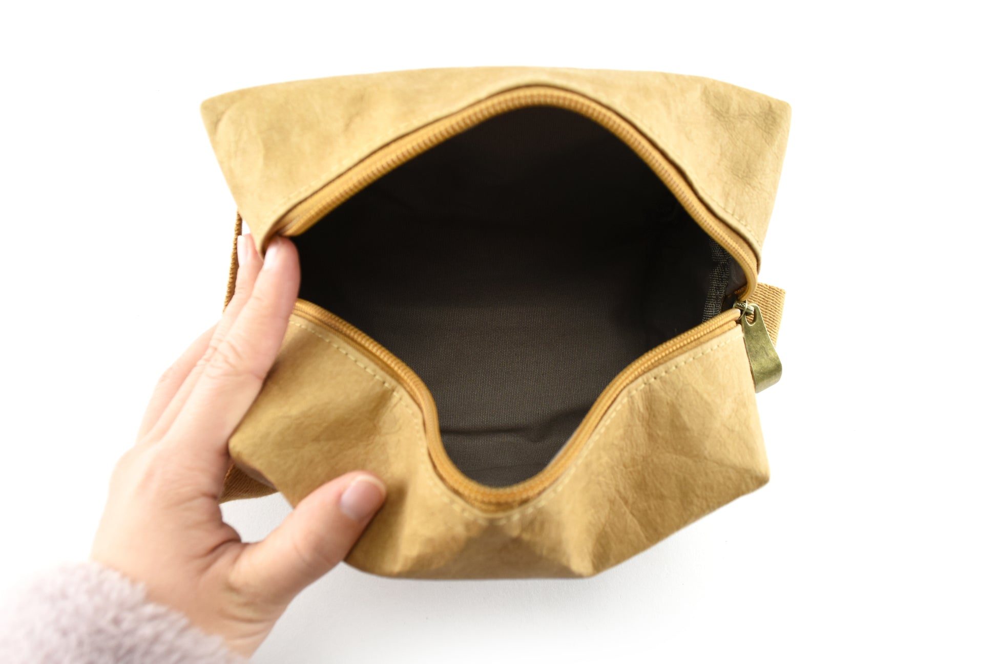 Munro Kraft Paper Cosmetic Bag shown from above, revealing the inside, highlighting its eco-friendly, durable design and spacious compartments for organizing cosmetics and toiletries.