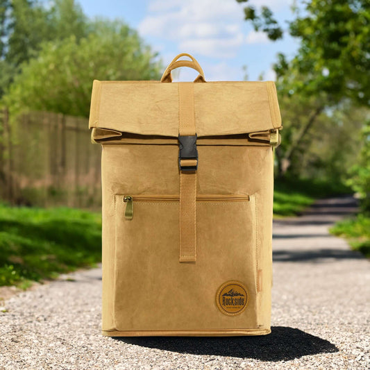 Somsonic Kraft Paper Laptop Backpack shown on a gravel trail, highlighting its outdoor durability and eco-friendly design for active lifestyles.