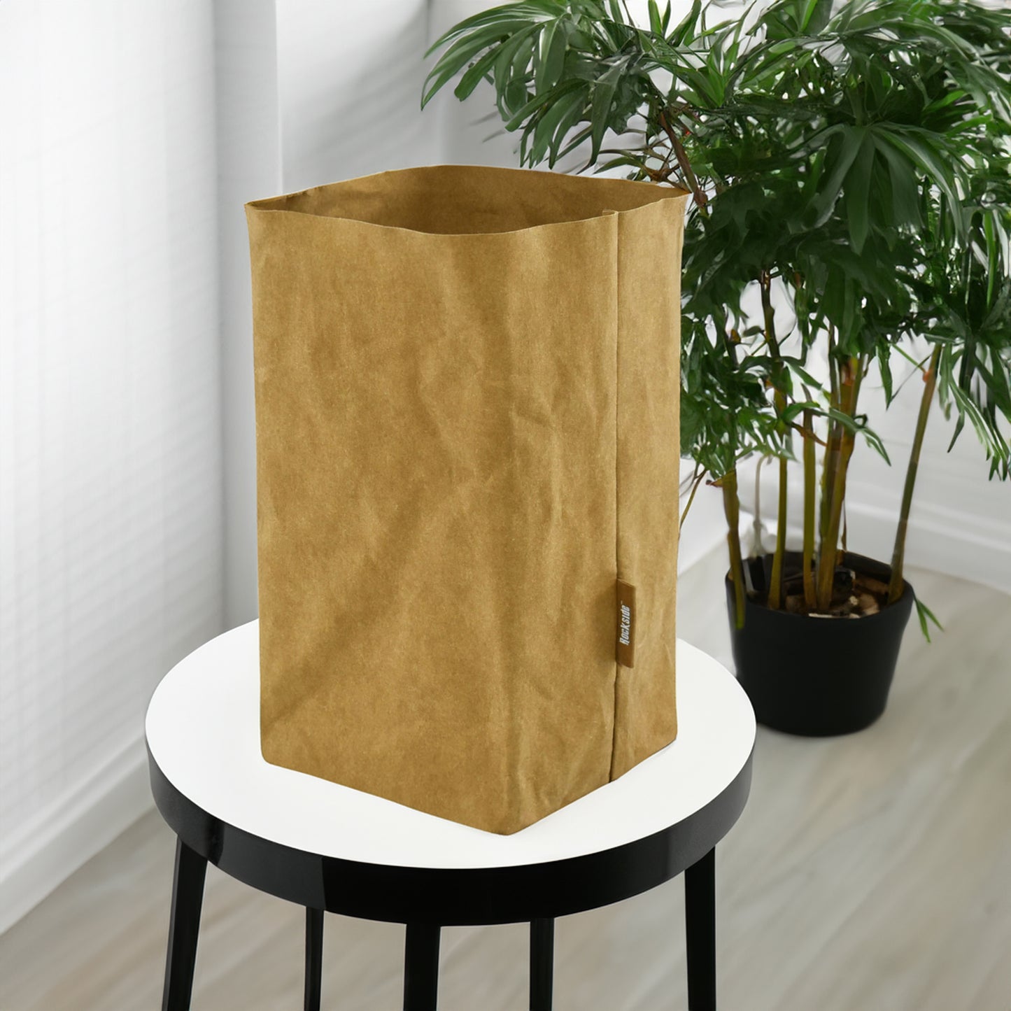 Sewo Kraft Paper Storage Bag – Large shown on a stool with a pot plant in the background, highlighting its eco-friendly design and spacious storage capacity